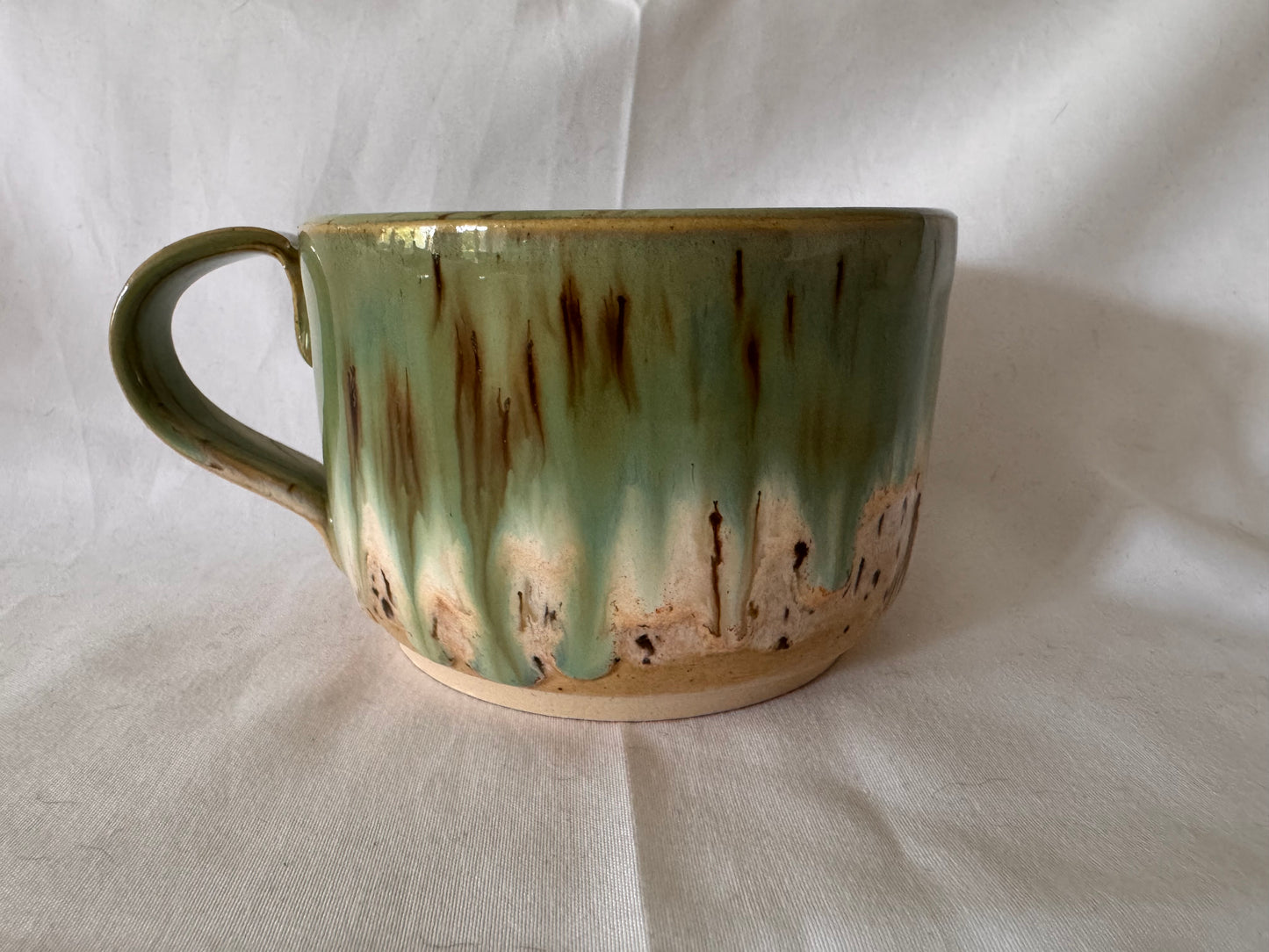 A rounded bottom mug (greens/ creams)