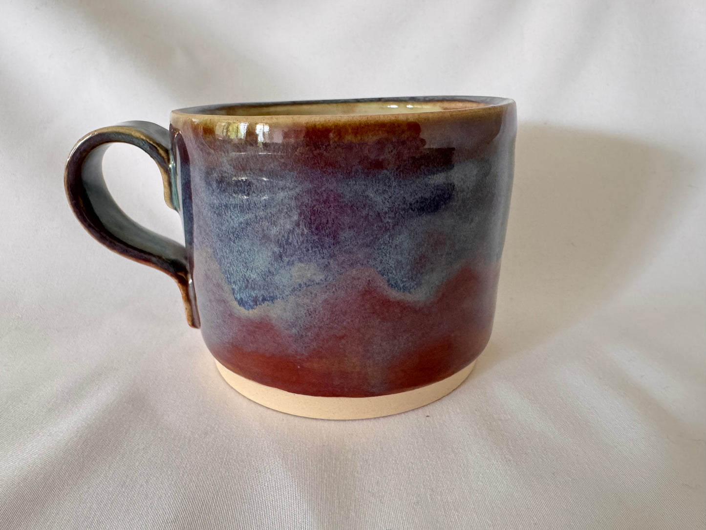 A mug (purple-blue outside, white inside)