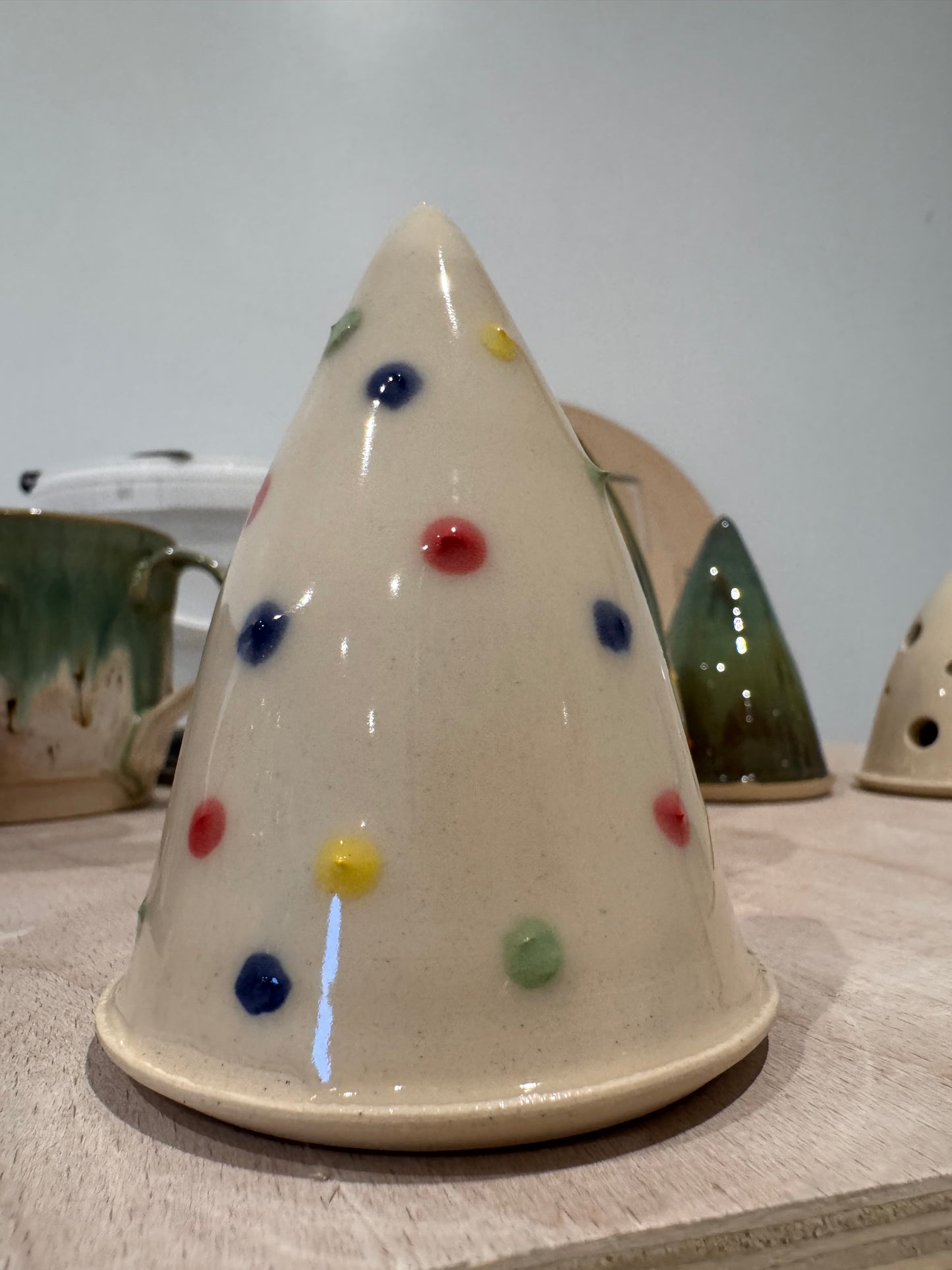 A Christmas tree ornament (cream/ baubles)