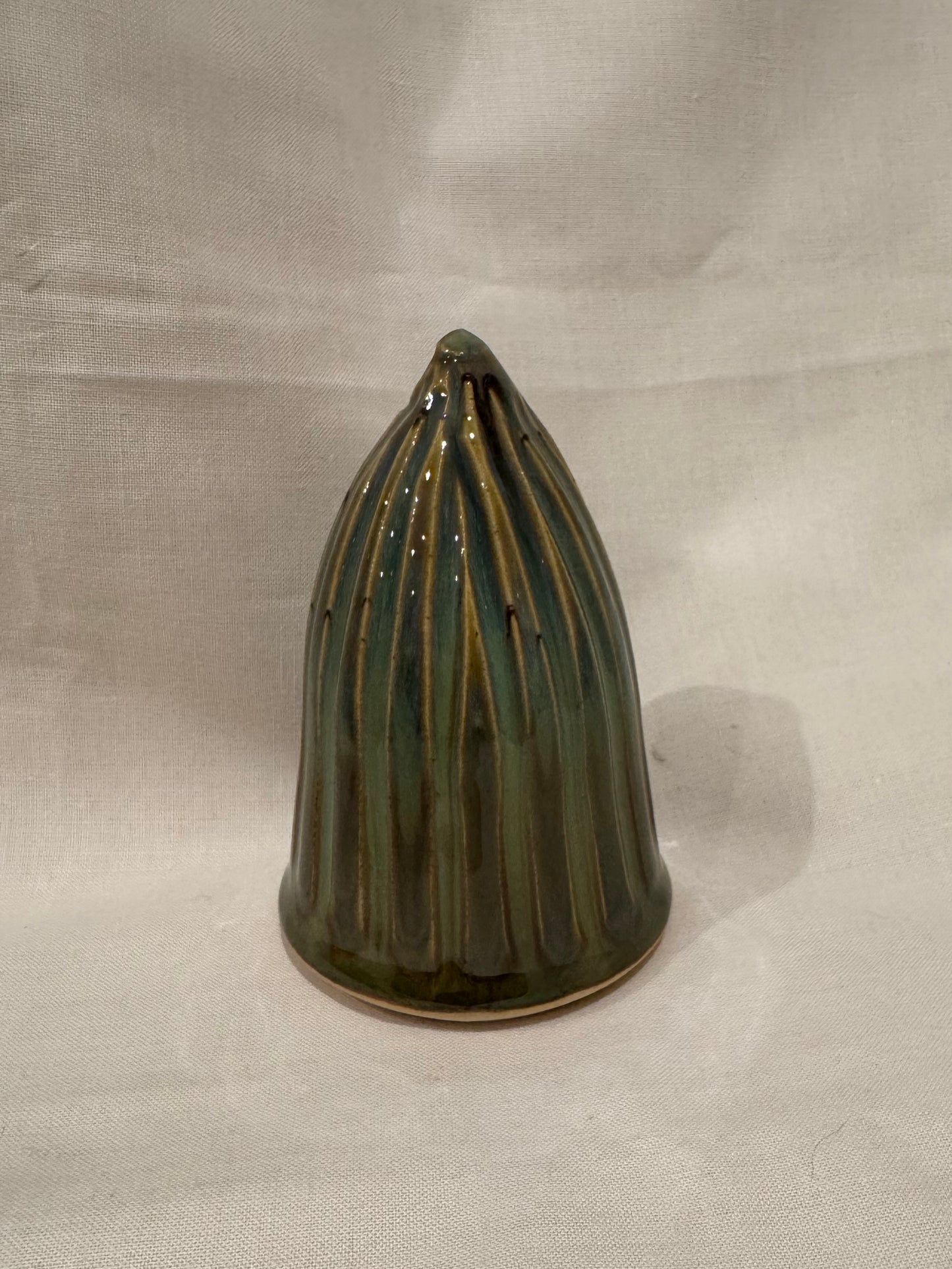 A Christmas tree ornament (green, fluted)