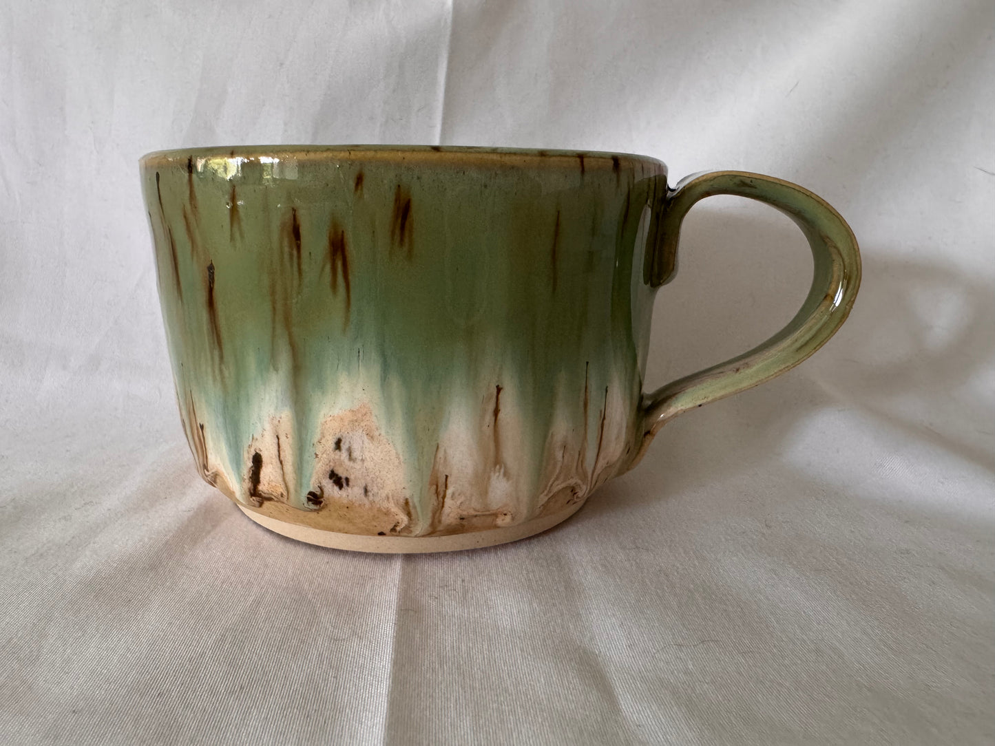 A rounded bottom mug (greens/ creams)