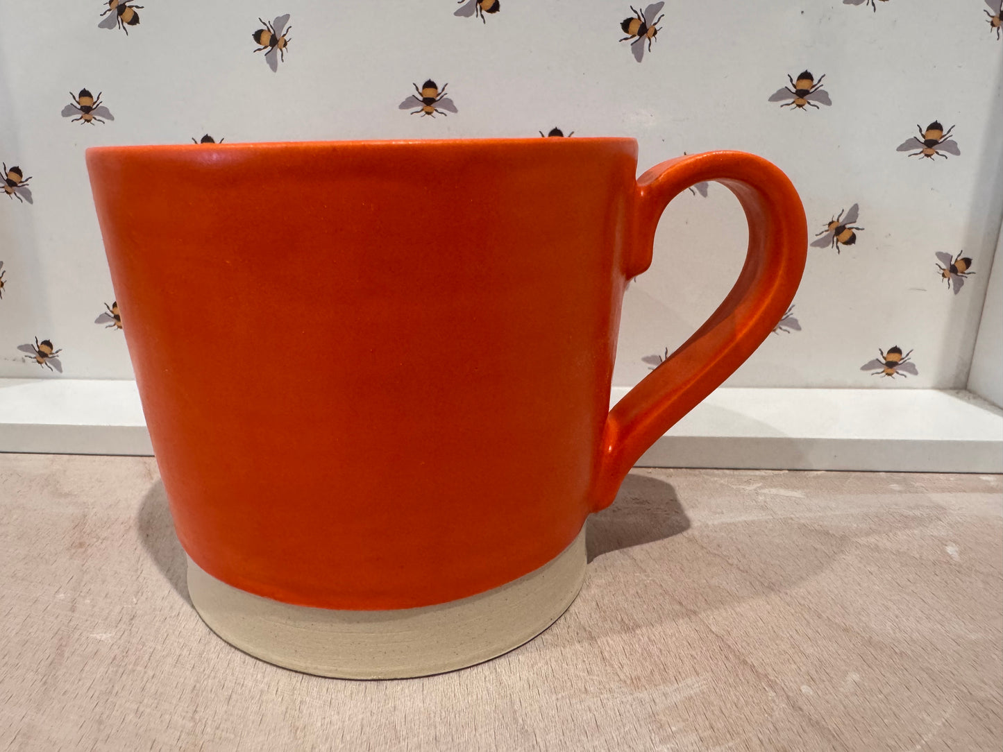 A  mug (bright orange)