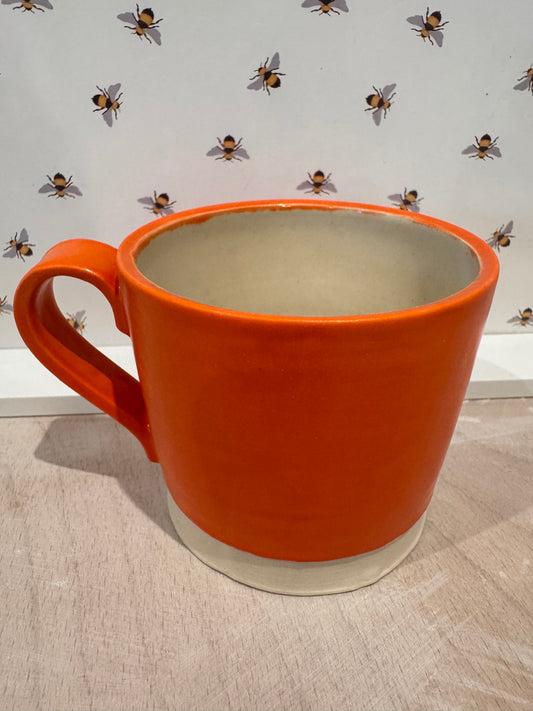 A  mug (bright orange)