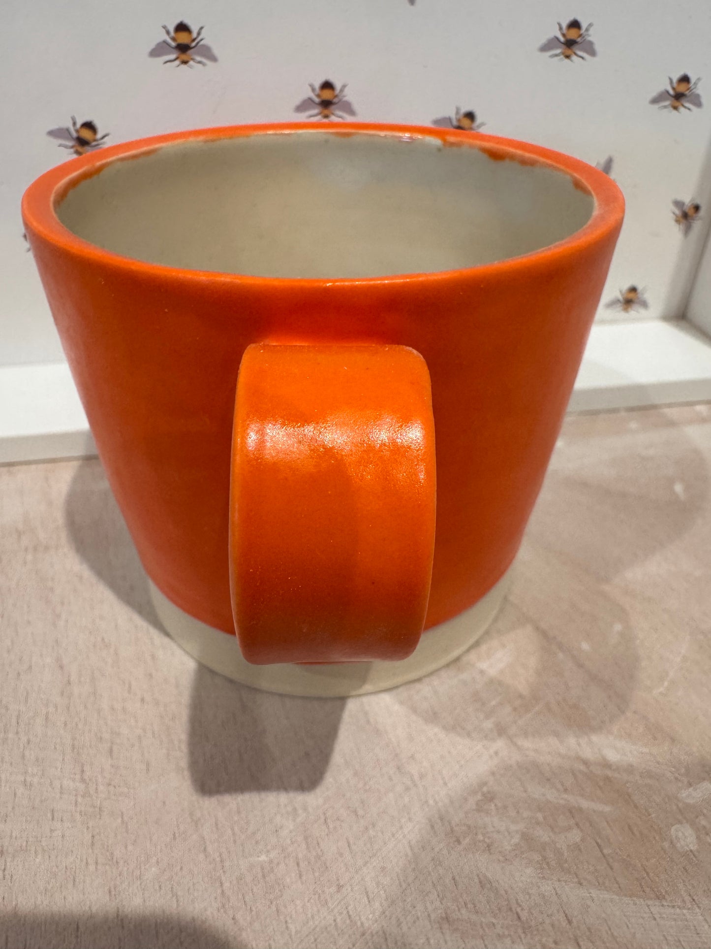 A  mug (bright orange)