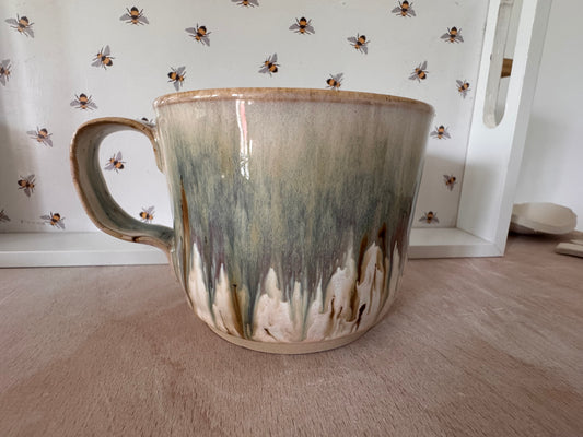 A mug (cream with bluey-purples, squared-off handle)