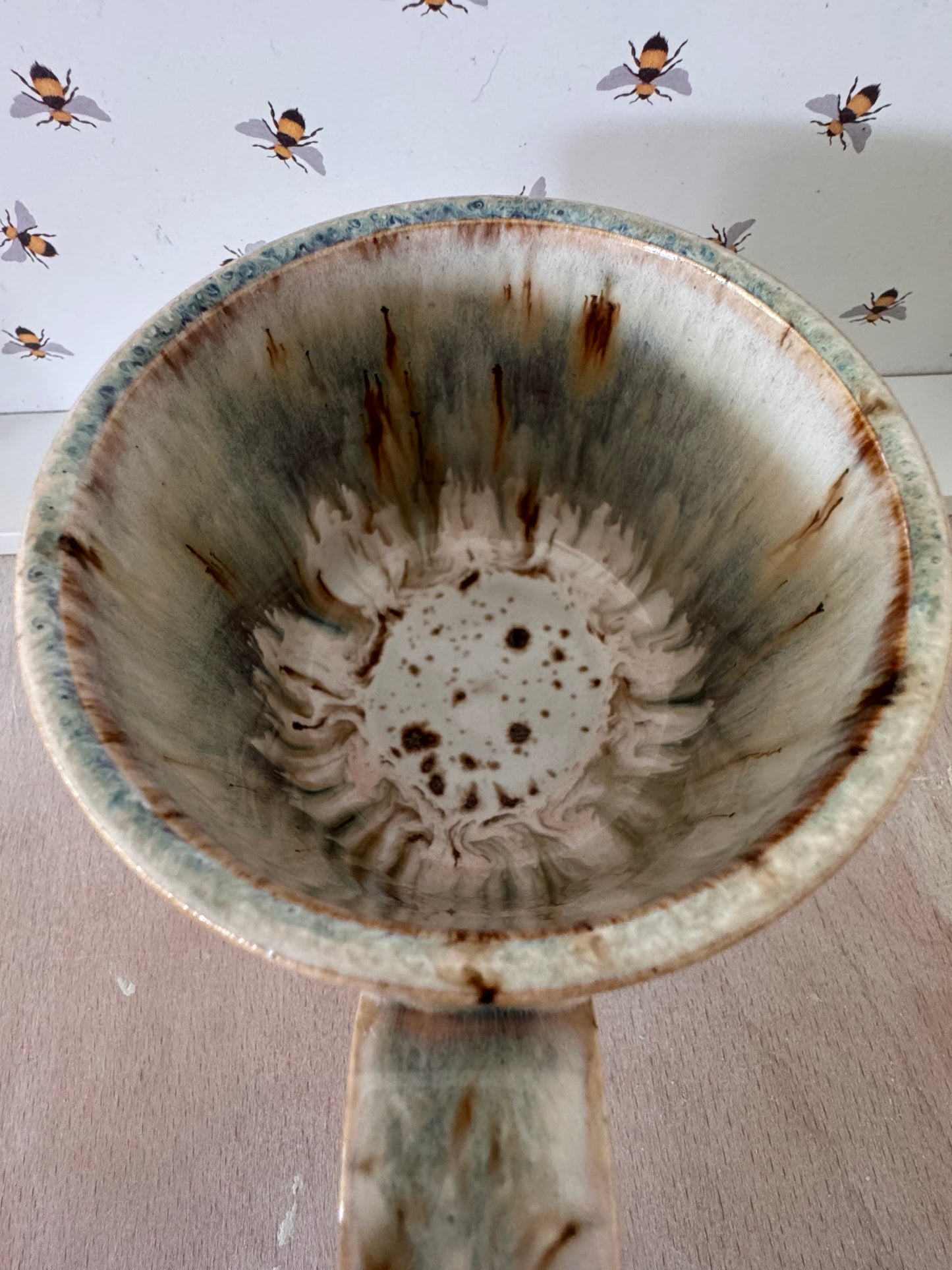 A mug (cream with bluey-purples, squared-off handle)