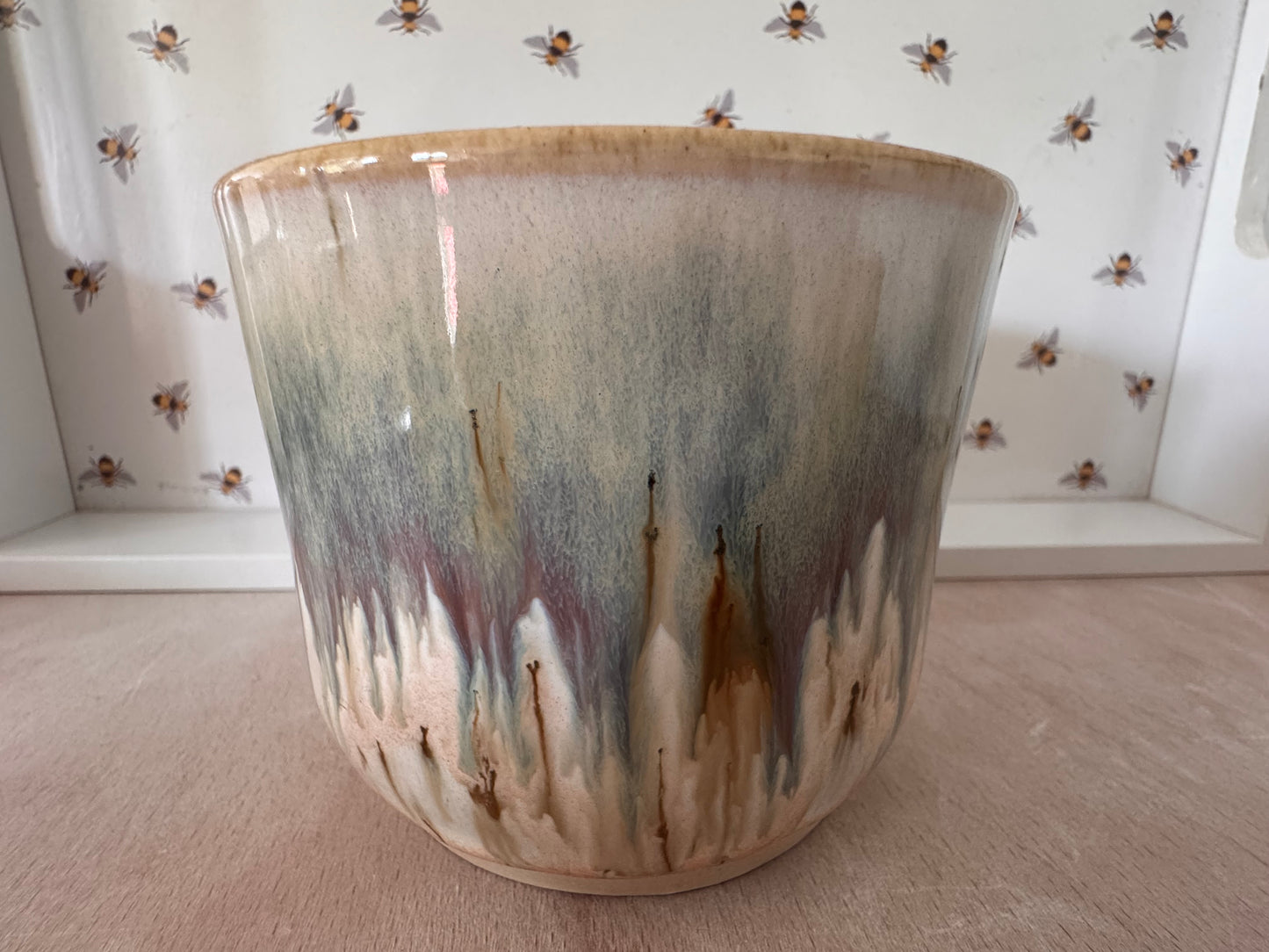 A mug (cream with bluey-purples, squared-off handle)