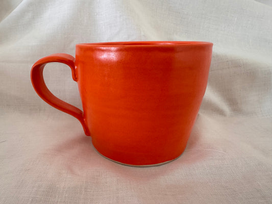 A mug (bright orange inside & out)