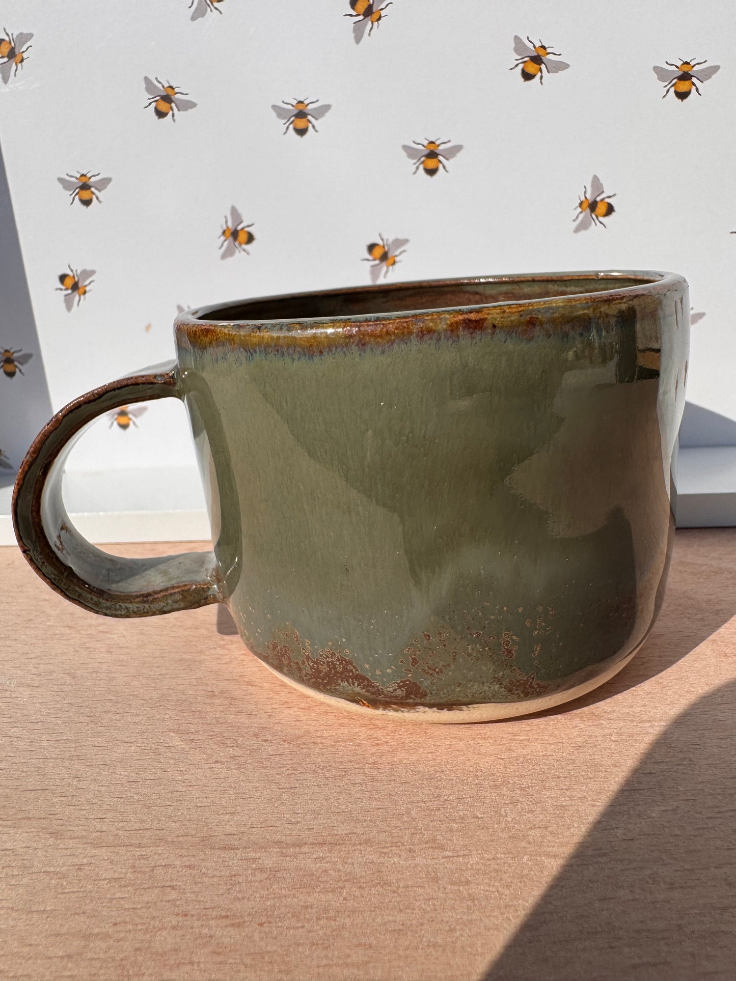 Hand thrown cup in mossy green